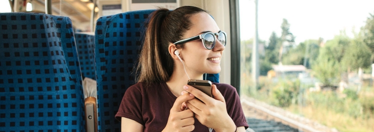 masthead-girl-on-train-listening-to-music