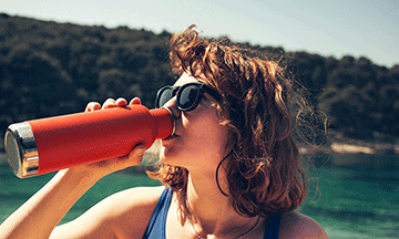 girl-drinking-water-from-reusable-bottle