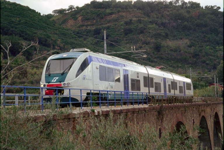 An Italian regional train crosses a bridge
