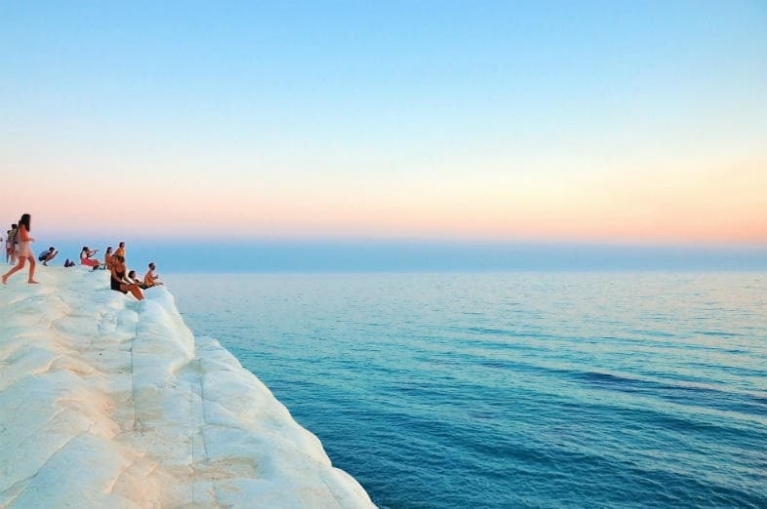 People standing on the white cliff at Scala dei Turchi in Realmonte