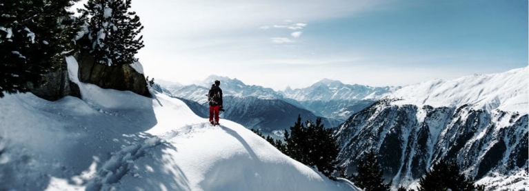 winter_travel_inspiration_-_man_standing_on_the_peak_of_the_snowy_mountain_at_aletsch_glacier_fieschertal_in_switzerland_desktop_2