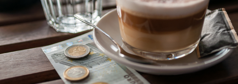paying-cup-of-coffee-euros-currency