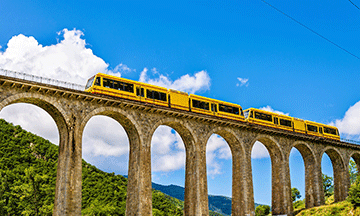 yellow-train-through-mountains-pyrenees