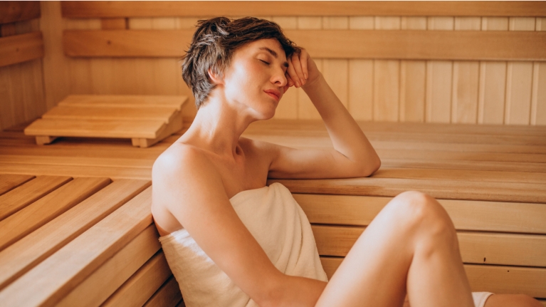 woman-resting-in-sauna-wood