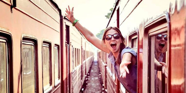 cheerful_woman_looking_out_the_window_of_the_old_train_edited